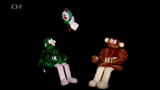 Muf se přestrojí jako budík a vykřikuje o sobě, že je Mufočas. Jůhelákům všechno sebere, že to tak prý čas dělá.