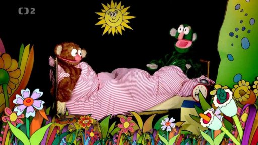 Jů a Hele leží v posteli, zaspali. Budík nezvonil. Jůheláci budí budík.