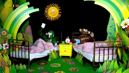 Jů a Hele posilují a ukládají si dobrou náladu čtením pěkných knížek, Muf jim to překazí horory jako je Perníková chaloupka.